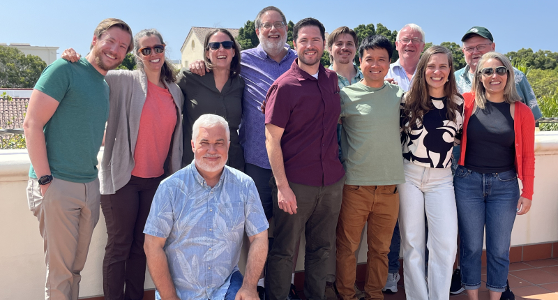 GO FISH working group smiling for a group photo on a sunny day on the NCEAS terrace.