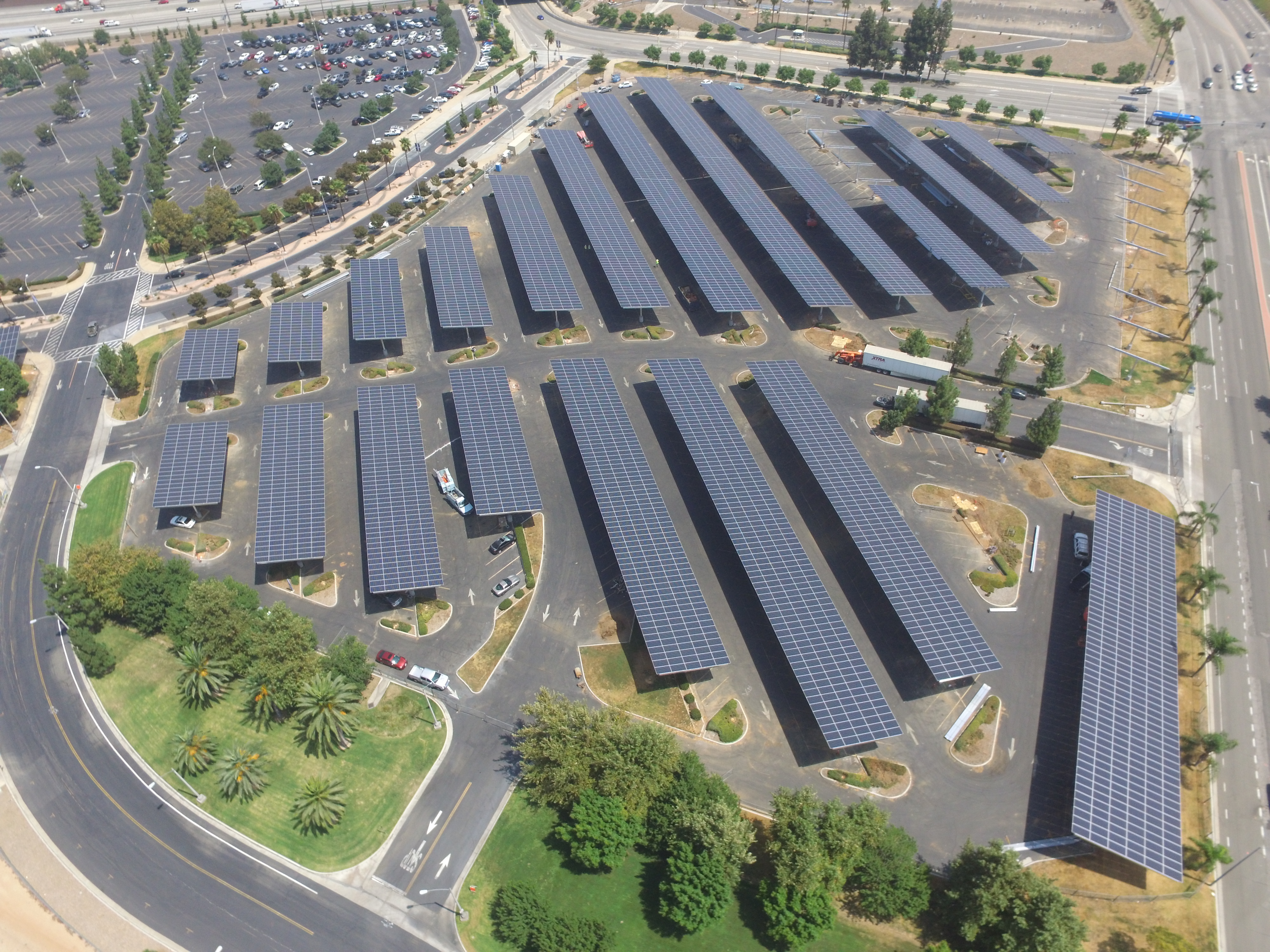 aerial view of solar panels, road and parking lots