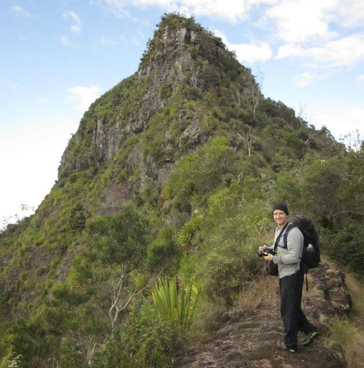 man hiking up a hill