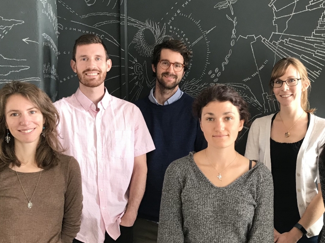 Seven people posing for photo