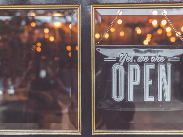 Open sign hanging in window