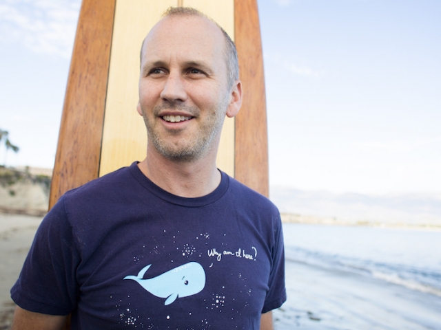 Ben Halpern standing with surf board on beach