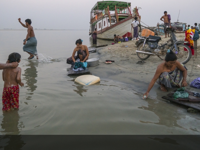 People bathing and washing in a river