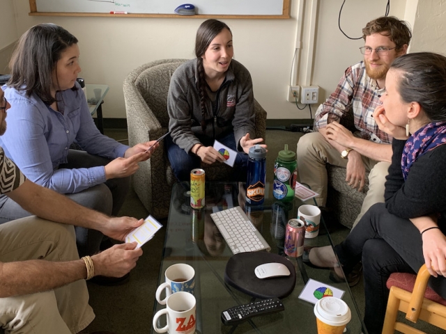 a group of people sitting in a meeting