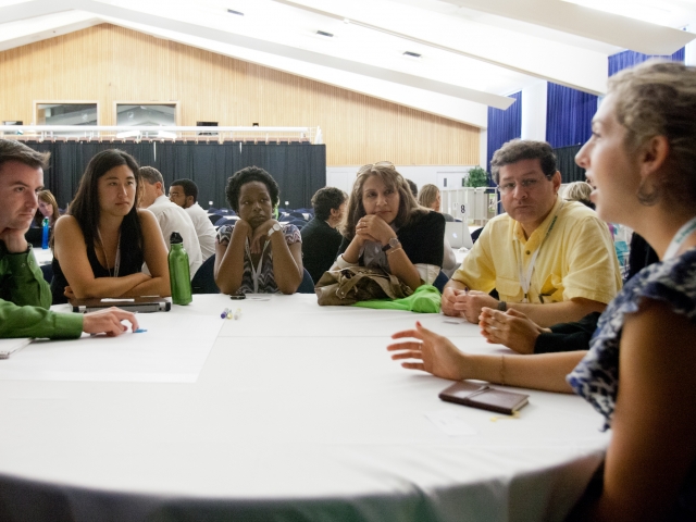 People conversing at a conference table