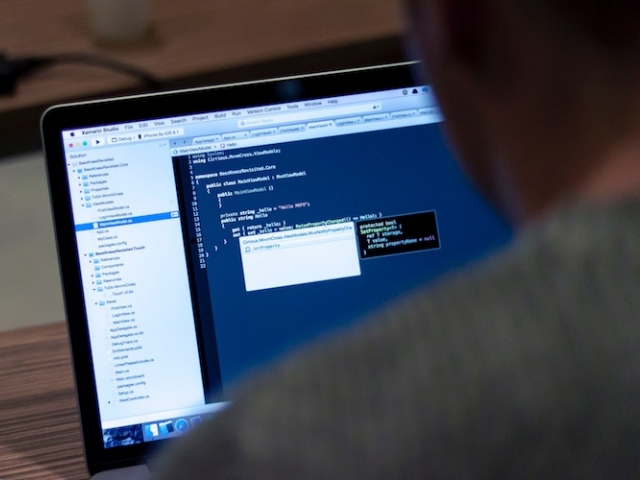 Man looking at code on computer