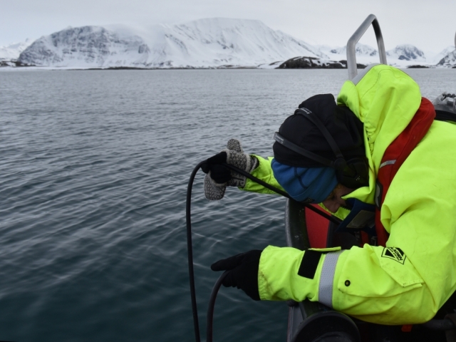 Researcher monitoring sound in the arctic