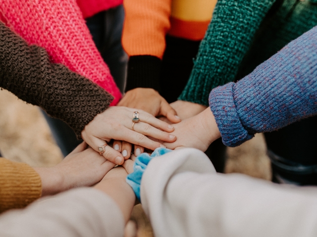 Hands all together in a circle