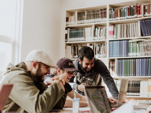 Data scientists laughing while working together