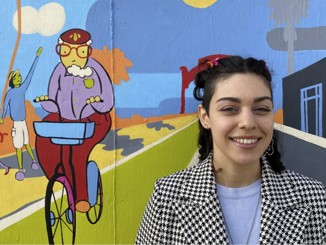 Leila Youfefi next to her mural 