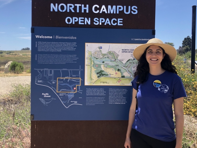 Carmen stands at the North Campus Open Space sign