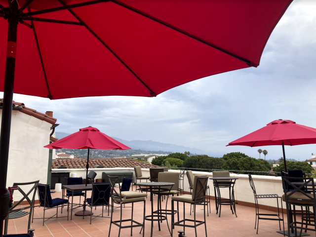 outdoor roof terrace with red umbrellas