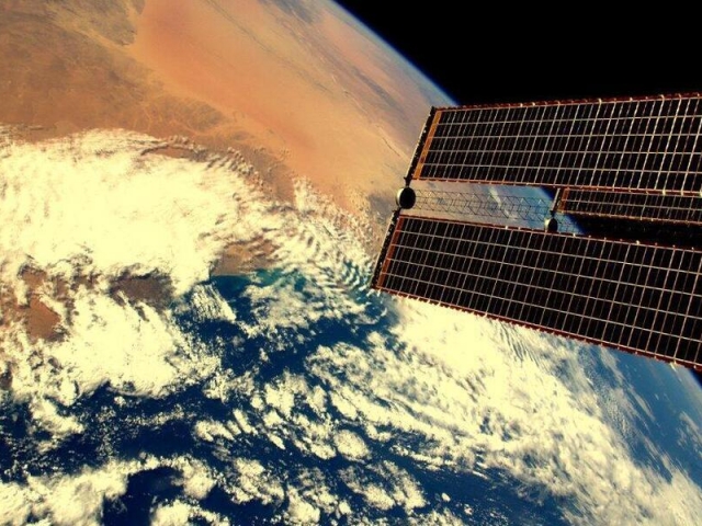 A satellite orbiting Earth. 