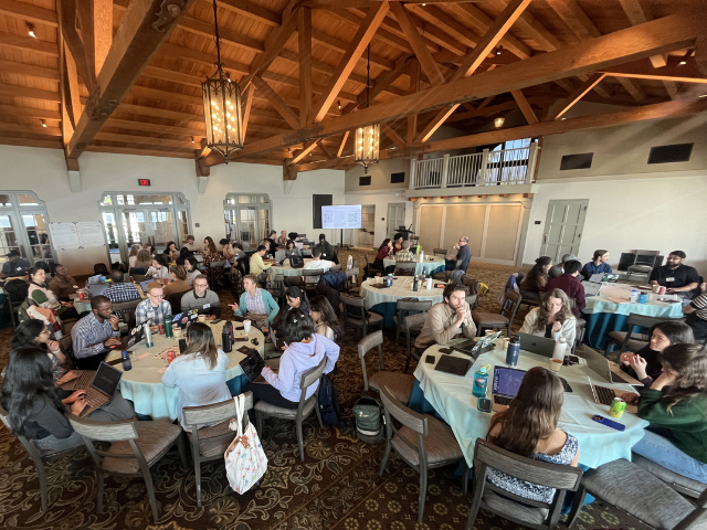 people working at tables at eds summit 2026