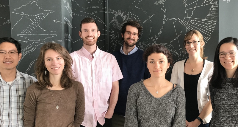 Seven people posing for photo