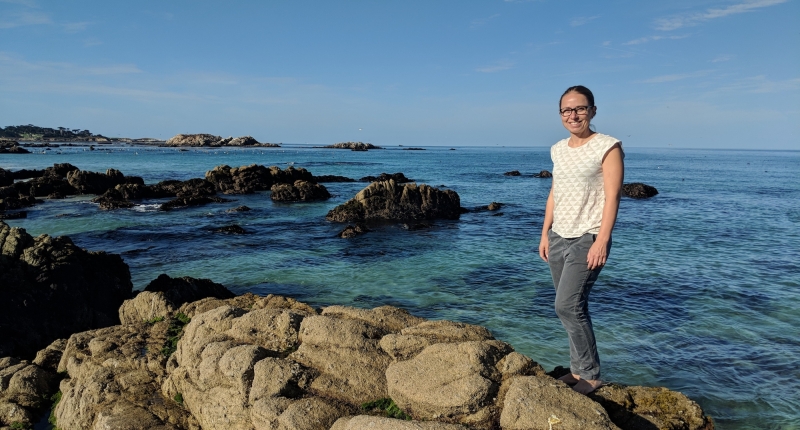Julie Lowndes on the rocks by the sea