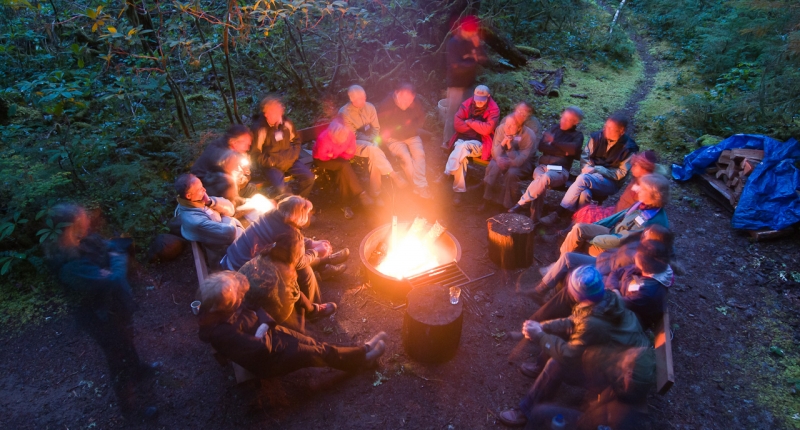 Group of about 15 people around campfire