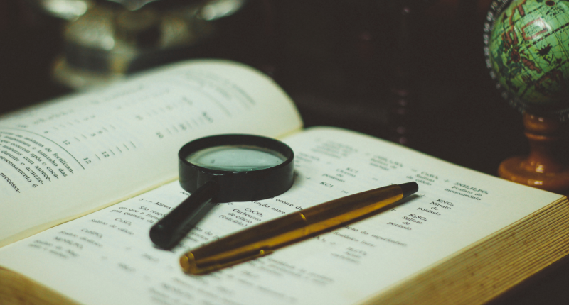 Magnifying glass lying on open book