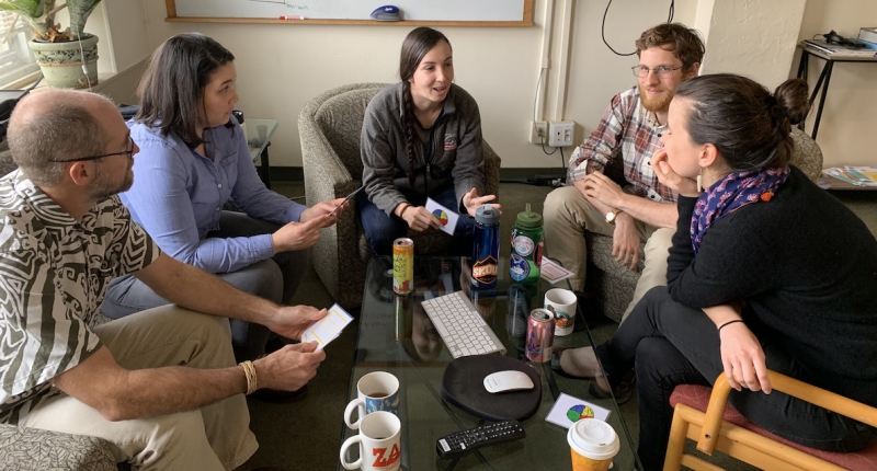 a group of people sitting in a meeting