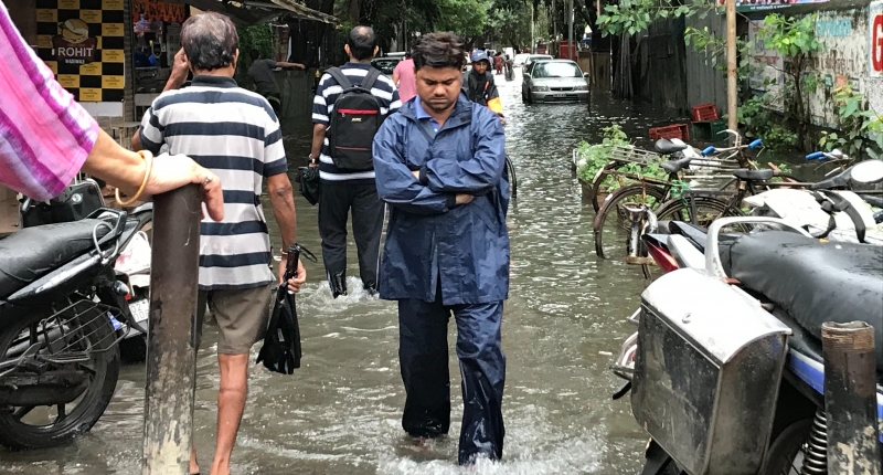 People walking in a flood street