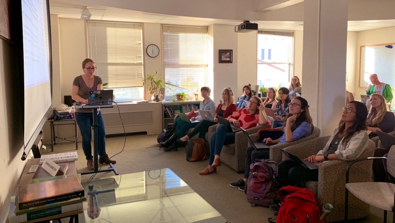 Woman presenting to an audience of women 