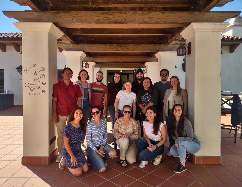 The participants and instructors of our October 2023 coreR course gathered in two rows on the NCEAS patio walkway at the end of their five days of training on R programming, open science, and reproducible data.