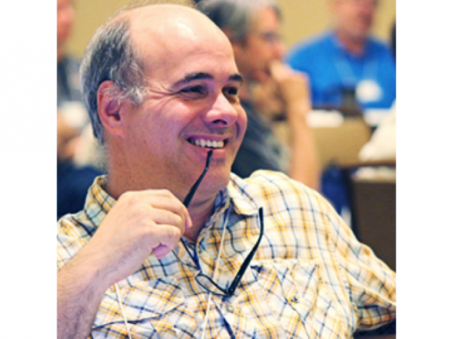 Man smiling with glasses in teeth