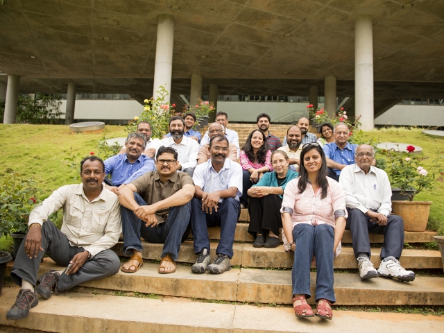 Group of people sitting on steps posing for photo