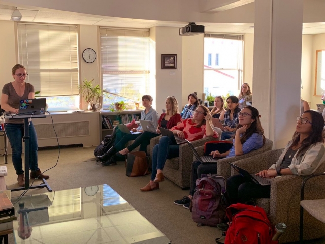 Woman presenting to an audience of women 