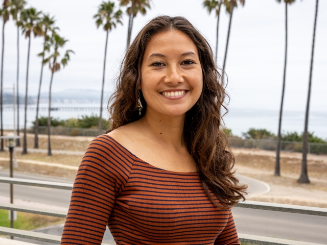 Halina Do-Linh headshot with palm trees and ocean in the background