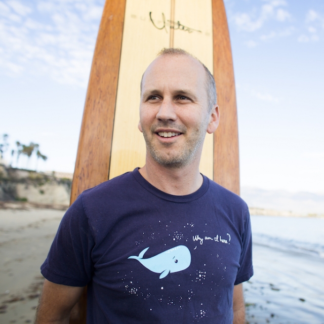 Ben Halpern standing with surf board on beach