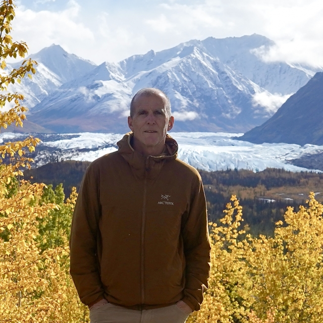 A headshot of John Sargent in the mountains